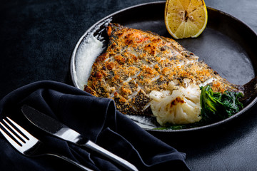 Wall Mural - Flounder fillet roasted in a skillet with herbs and lemon