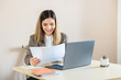 © Andrei - HR manager beautiful woman smiling comparing CV of job candidates