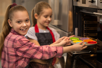 Two little girls sisters cooking together