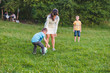© phpetrunina14 - mother play with son in ball at green field.