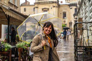 Poster - woman walking with transparent umbrella under rain