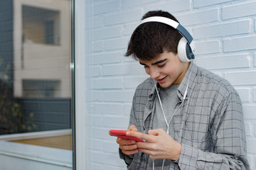 teenager or student with mobile phone and headphones