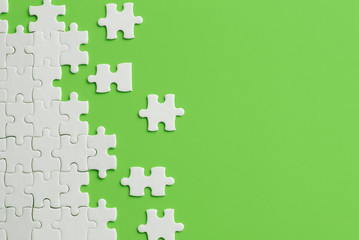 Wall Mural - White details of puzzle on green background
