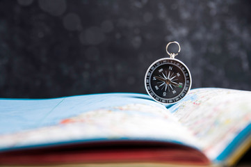 Wall Mural - Old compass and map  on a dark background. Copy space for text or design