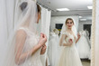 © RomanR - Young bride in salon looking in mirror at her reflection