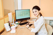 © Iuliia Gorshkova - dentist girl sitting at the table at the computer and makes a record