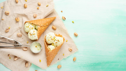 Wall Mural - Ice cream with pistachios on a light background, with space. Summer mood