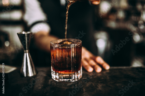 Cuadros en Lienzo A close up shot of a bartender pouring whiskey