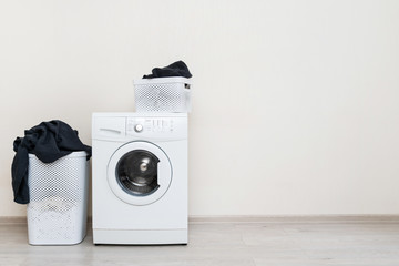 Laundry room interior with washing machine near wall