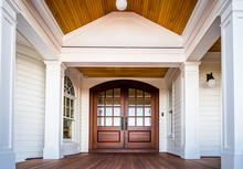 Front Entry Way Of House Featuring PVC Trim, Woodwork, Columns, And Deck