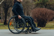 © Nana_studio - Close-up of male hand on wheel of wheelchair during walk in park