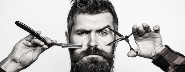 Bearded man, bearded male. Portrait of stylish man beard. Barber scissors and straight razor, barber shop. Vintage barbershop, shaving.