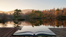 Beautiful Landscape Image Of Tarn Hows In Lake District During Beautiful Autumn Fall Evening Sunset With Vibrant Colours And Still Waters Coming Out Of Pages In Magical Story Book