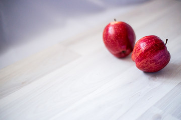 two red apples on a light background