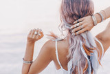 Fototapeta Boho - beautiful young boho woman close up with pink feathers and accessories at sunset