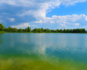 Fabulous beautiful view of the lake and forest green in nature. Summer landscape.