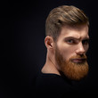 Fashion model with stylish hair and beard. Barber fashion and beauty. Portrait of handsome single bearded young man with serious expression