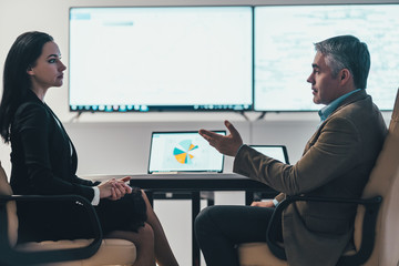 Wall Mural - The business woman and a man discussing at the table in a modern office