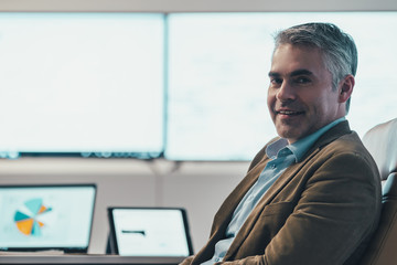 Wall Mural - The businessman sitting in the modern office