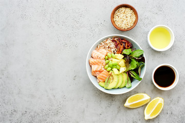 Wall Mural - Salmon poke bowl with salad, avocado, edamame beans, pineapple and sesame Brown rice poke bowl Top view, clean eating concept Traditional Hawaiian dish