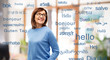 © Syda Productions - vision and old people concept - smiling senior woman in glasses over greeting words in different foreign languages