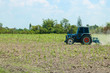 Tractor ploughing a sugarcane field of dust behind