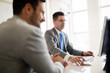 © NDABCREATIVITY - Image of two handsome businessmen using computer at meeting