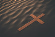 Wooden cross floating on water surface at dawn. Conceptual image baptism