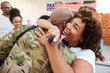 Millennial black soldier returning home to his family, embracing his mother, close up