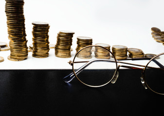 background of financial and accounting concept with coin stacks, glasses, selective focus Concepts of tax planning