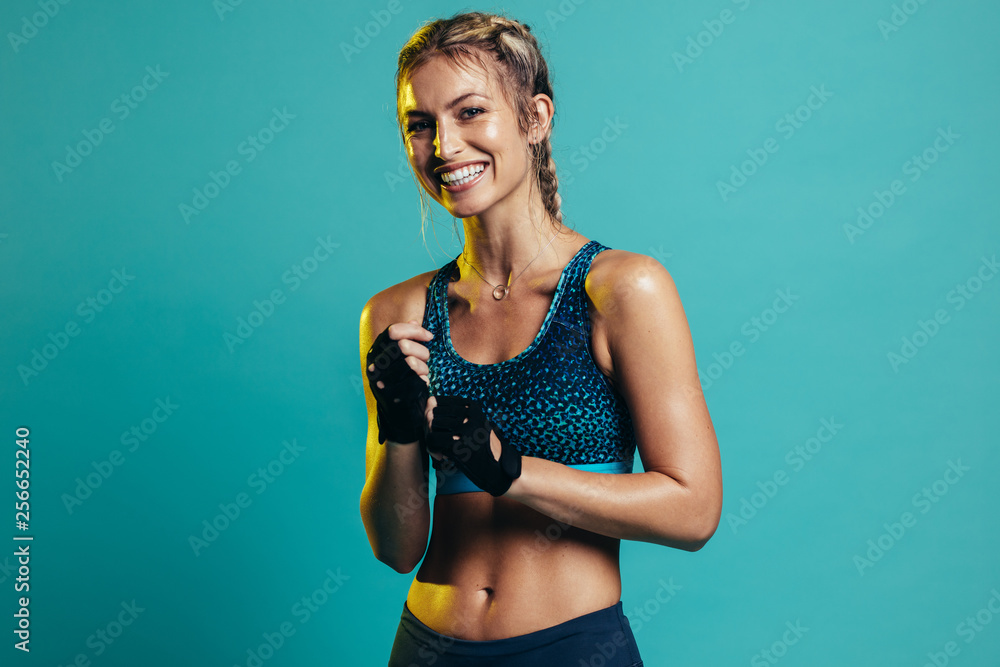 Smiling female fitness model - obrazy, fototapety, plakaty 