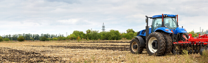 Poster - Tractor with plow working in the field