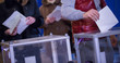 © Sodel Vladyslav - Illustrative image of the election in a democratic society. Elections in Ukraine. The process of voting at a polling station. The voter throws the ballots in the ballot box.
