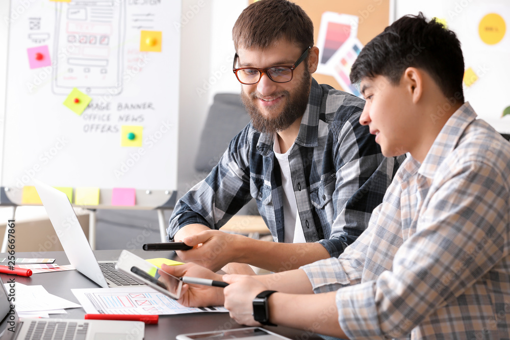 Young IT designers working in office