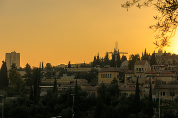 Wall Mural - Jerusalem's quarters outside old city walls at sunset