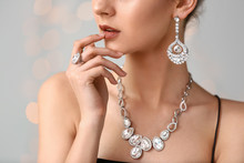 Young Woman With Beautiful Jewelry On Light Background, Closeup