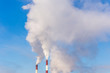 © Andrey - Smoke from two pipes on blue sky background in a cold winter day. City pollution in historical Saint-Petersburg, Russia