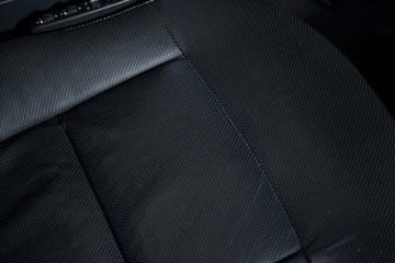 Detail shot of black leather car seat 