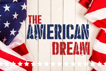 Wall Mural - top view of american flags and the american dream lettering on white wooden surface