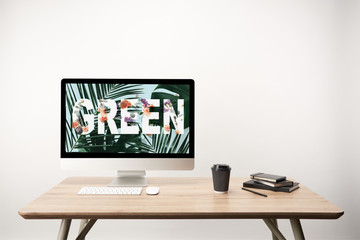 Sticker - computer with green leaves and green lettering on monitor on wooden desk