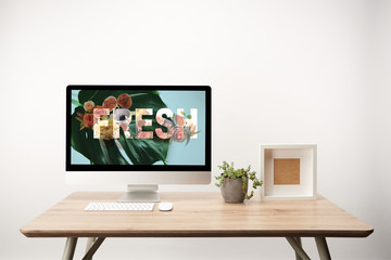 Sticker - computer with green leaves and fresh illustration on monitor on wooden desk