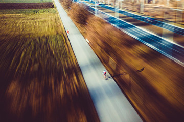 Poster - Aerial cyclist sunny day at bicycle path travel with motion