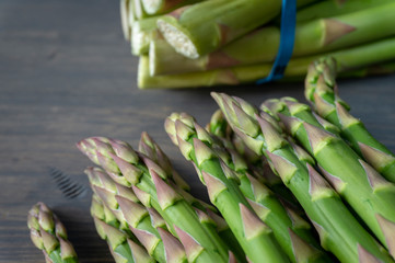 Fresh green asparagus on wooden background