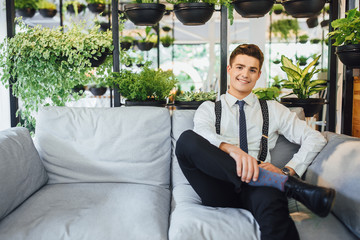 Wall Mural - handsome businessman sitting in an office on a summer terrace