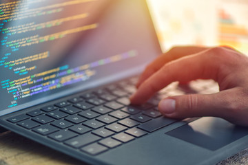 Closeup coding on screen, hands coding html and programming on screen laptop, web development, developer