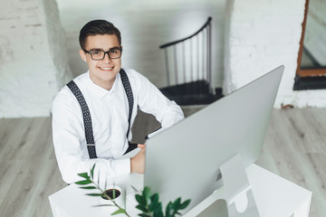 Wall Mural - Young businessman  with his computer. Working at office, modern style.