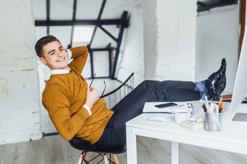 Wall Mural - Young businessman resting at his office during break.