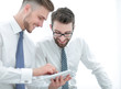 © ASDF - close up.two employees looking at the digital tablet screen