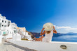 © Netfalls - Luxury travel vacation woman looking at view on Santorini island