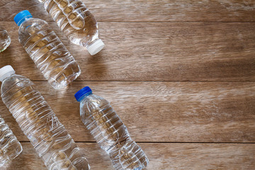 Wall Mural - Drinking water bottles on grunge vintage wooden background